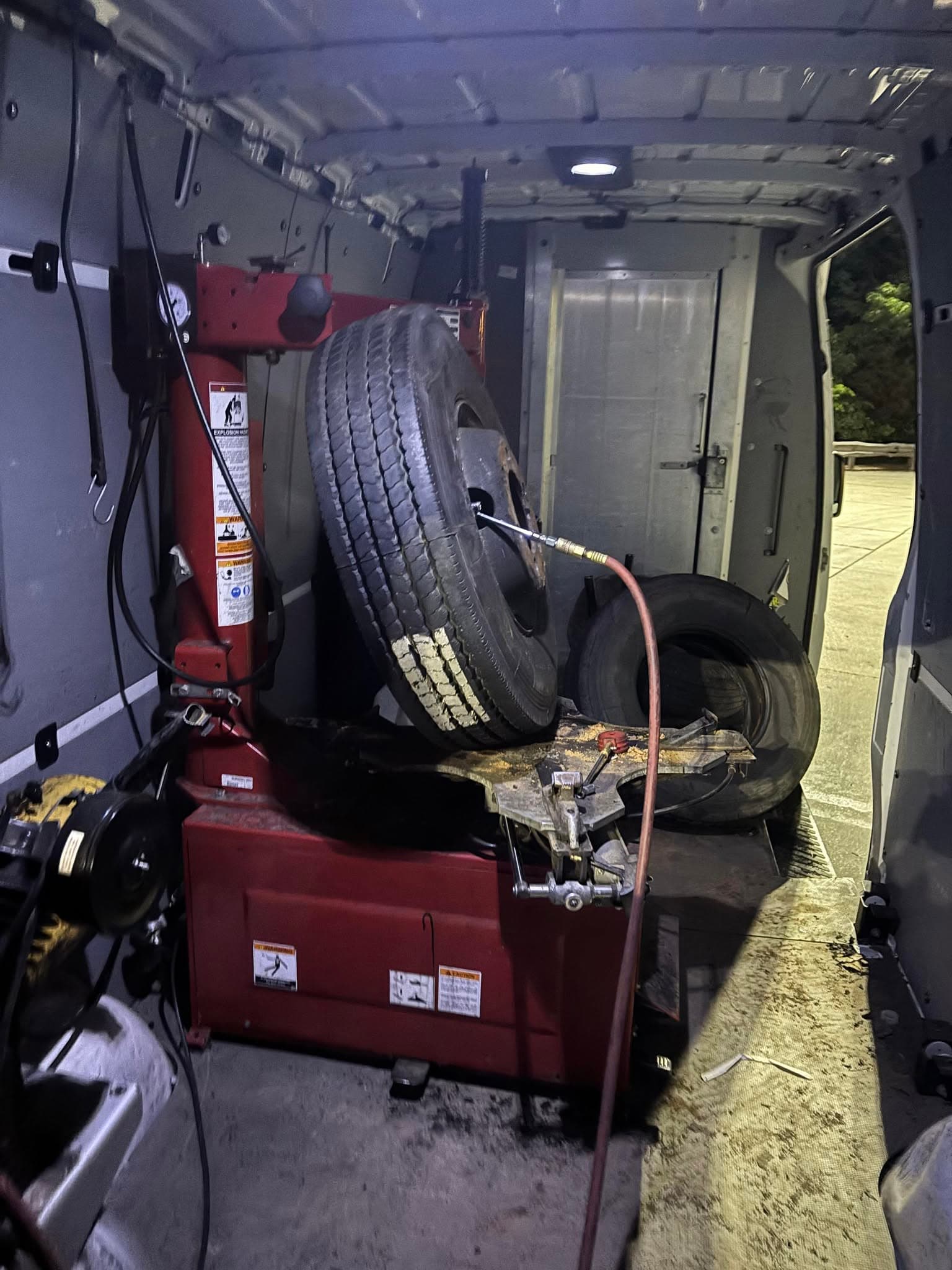 Inside a Tires 4 Less Roadside service van, fully equipped with tire changing equipment